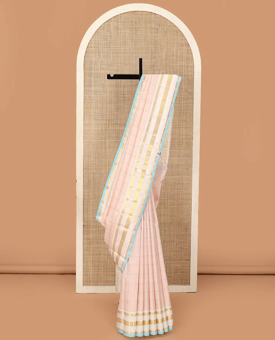 Baby pink checked Kanchipuram silk saree, contrast varisai pettu border of thilakam mokku, manga, and kuyil kann designs, and seppu rekku pallu