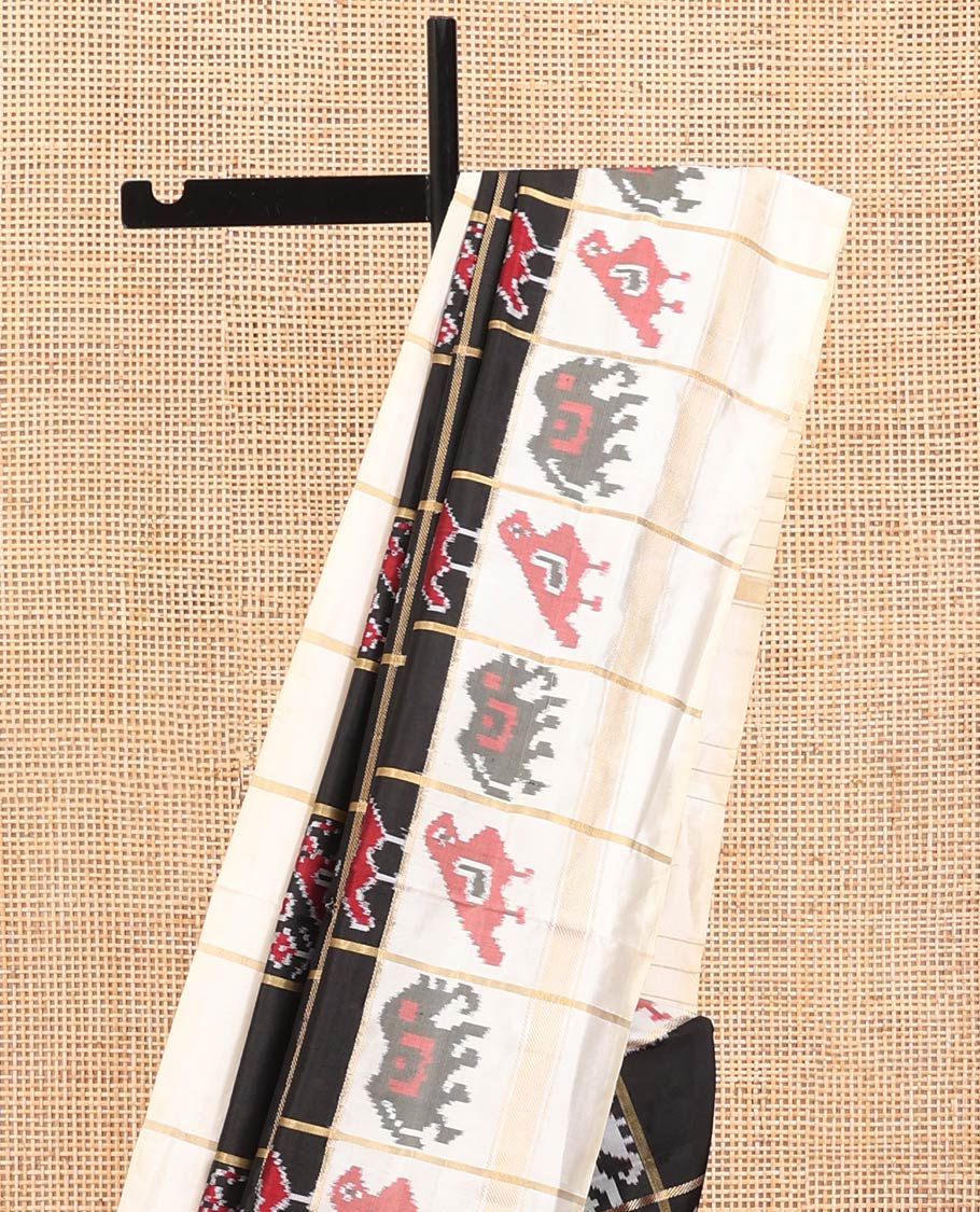 Black Ikkat Silk Saree, Impeccably Styled with Patola-Style Parrot-Elephant Butta Enclosed Checks on Its Body, Complemented by a Contrast Patola-Style Parrot-Elephant Butta Enclosed Border, Pallu of the Same Motifs, and Paired with a Contrast Blouse - Image 3