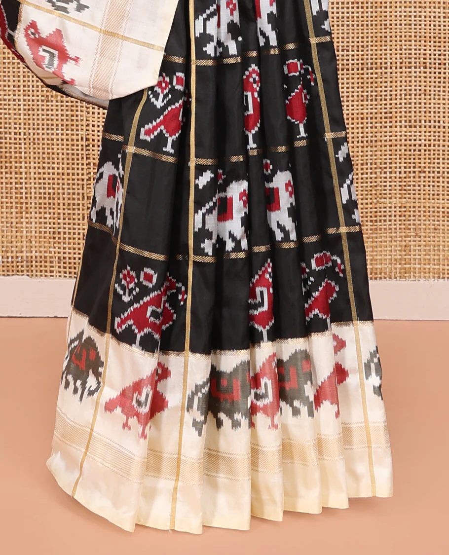 Black Ikkat Silk Saree, Impeccably Styled with Patola-Style Parrot-Elephant Butta Enclosed Checks on Its Body, Complemented by a Contrast Patola-Style Parrot-Elephant Butta Enclosed Border, Pallu of the Same Motifs, and Paired with a Contrast Blouse - Image 4