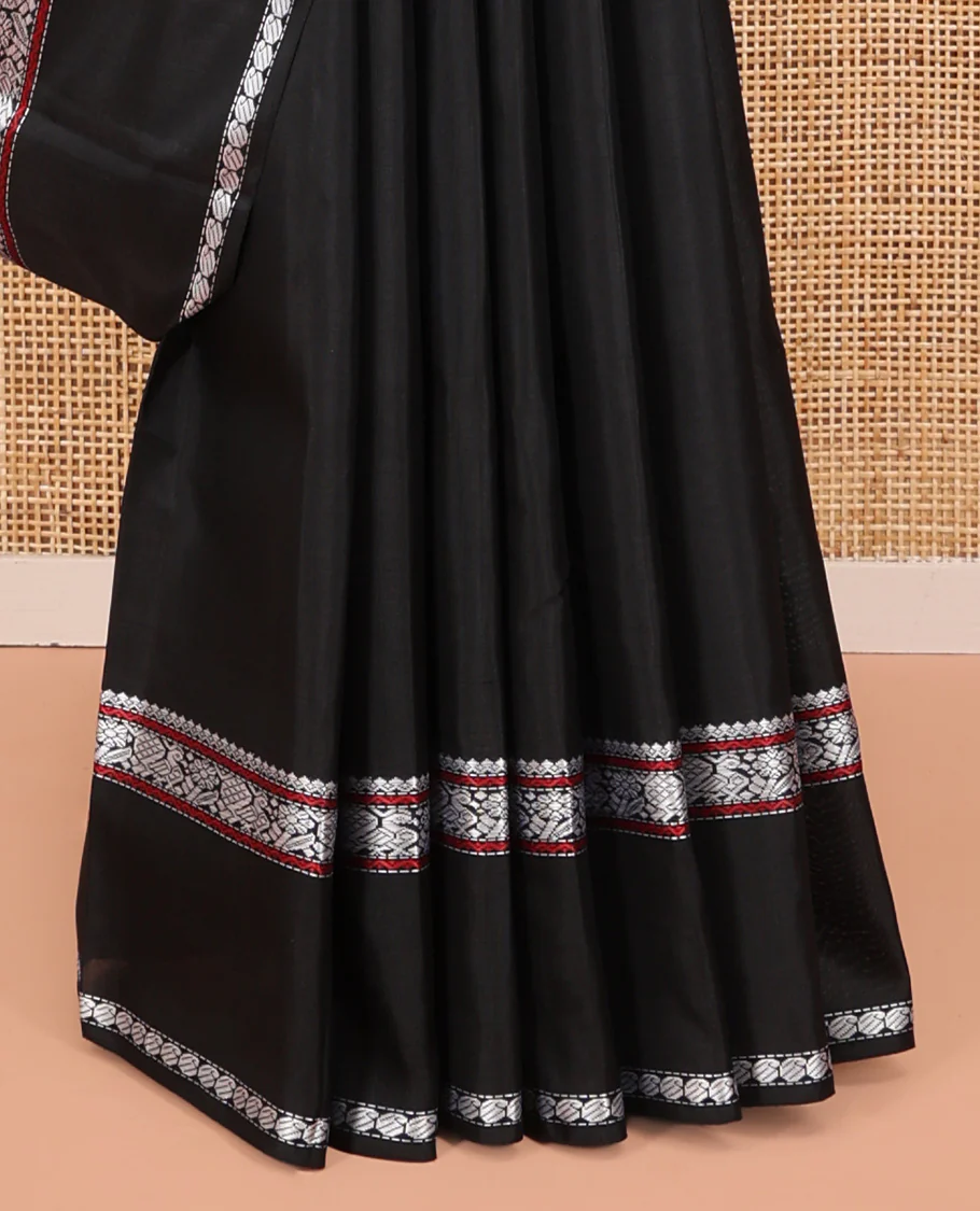 Black Kanchipuram Silk Saree, Delicately Woven with Buttas All Over Its Body, Highlighted by a Rettai Pettu Border of Thilakam Mokku, Neli, Mayil, and Manga Designs, Pallu Steeped with Stripes, and Paired with a Matching Blouse - Image 4