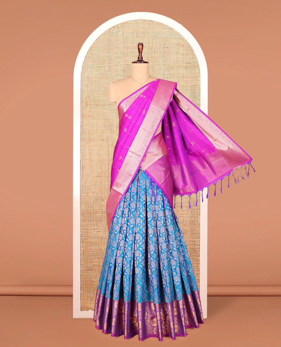 Blue Art Silk Material Half Saree Set, Majestically Detailed with Floral Jaal Jacquard Design on Its Skirt, Complemented by a Contrast Floral Zari Design Border, Paired with a Contrast Blouse, and Zari Design Dhavani
