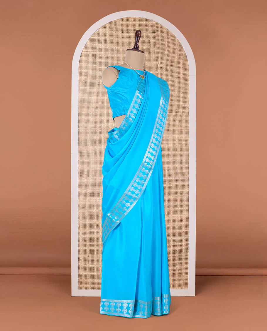 Blue plain Mysore silk saree, two-headed eagle zari woven border, and pallu of two-headed eagle motifs