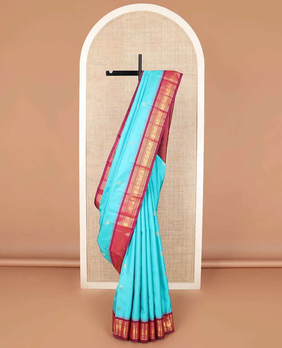 Blue mayil chakram buttas Kanchipuram silk saree, contrast thazampoo rekku border of thilakam mokku, banaras, rudraksham, and mayil designs, and intricate pallu