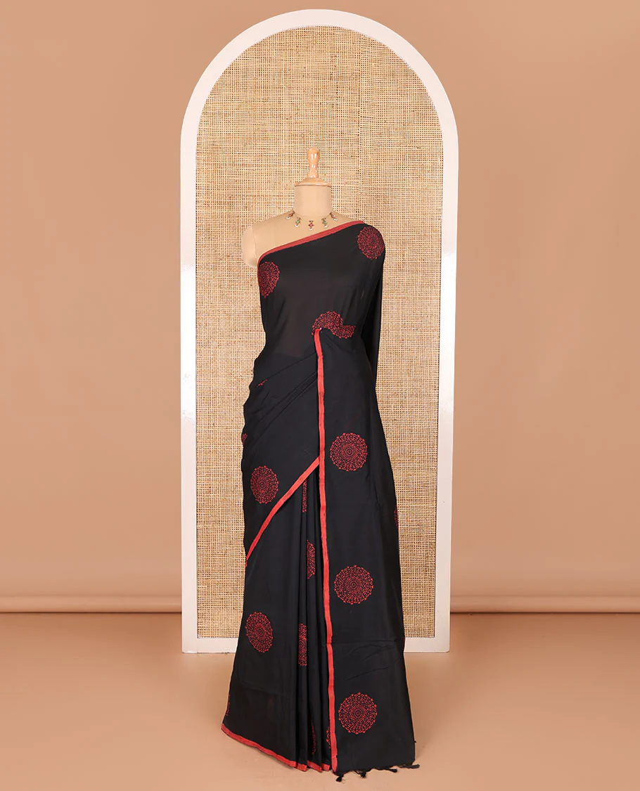 Borderless black rangoli-style chakram motifs printed South cotton saree with a matching blouse, and a contrast floral printed blouse - Image 2