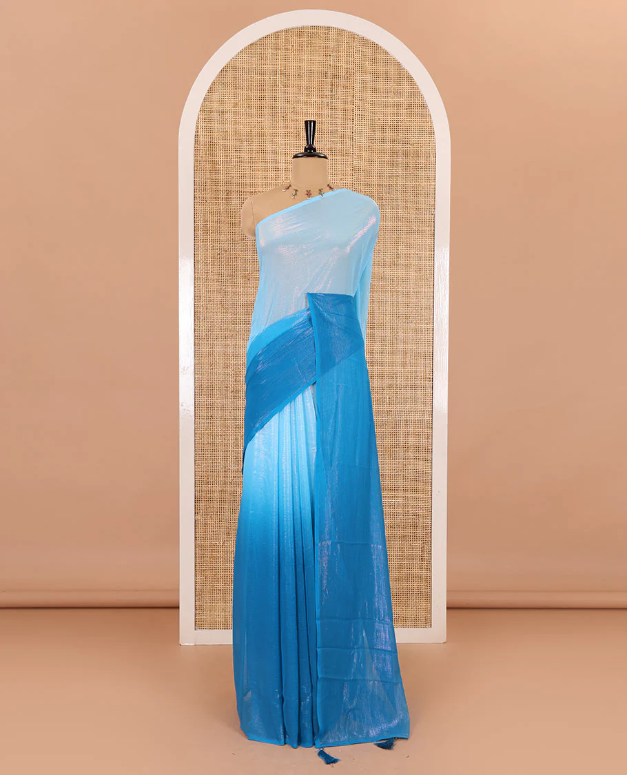 Borderless blue ombre-toned gleaming Shimmer Georgette saree, self-pallu with tassels and a plain blue blouse - Image 2