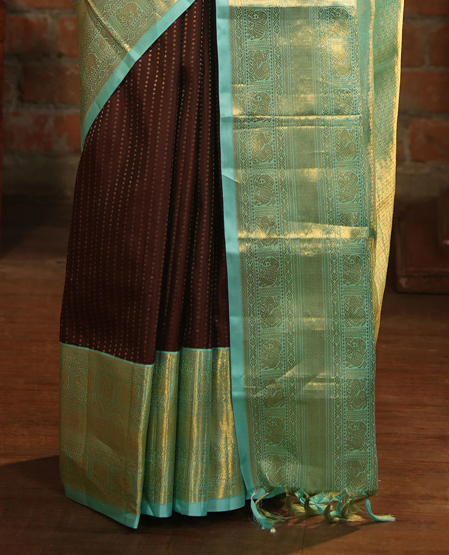 Brown Vasundhara Silk Saree Delicately Woven with Zari Buttas, Highlighted with a Contrast Border of Cross Kamalam, Mayil, Banaras, Yaanai, and Mayil Kann Designs, Pallu Grandly Woven with Jaal Designs, and Paired with a Contrast Blouse - Image 6