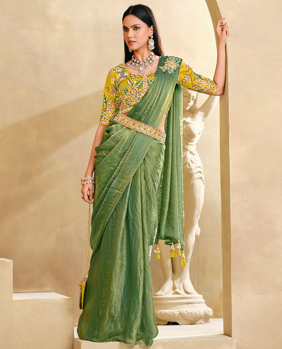 Cardamom Green Plain Party Wear Designer Saree, Complemented with a Contrast Round Neck Heavy Embroidered 3/4th Sleeve Readymade Blouse, Detachable Embroidered Belt, and a Free Embroidered Flap Sling Bag
