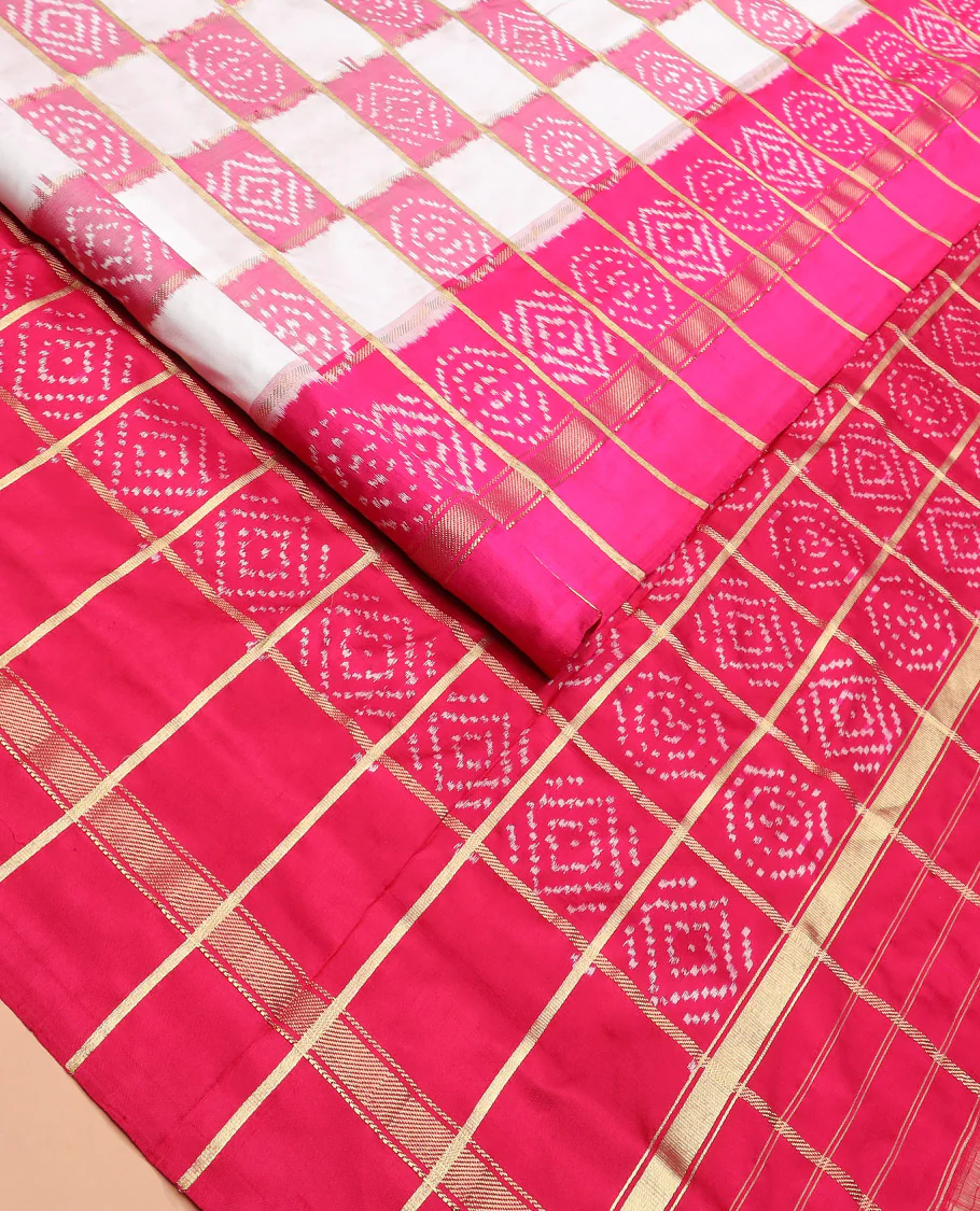 Cream and Pink Ikkat Silk Saree with Ikkat Buttas Enclosed in Checks, Complemented by a Contrast Ikkat Design Border, a Hazily Woven Pallu of Ikkat Patterns, and a Contrast Checked Blouse