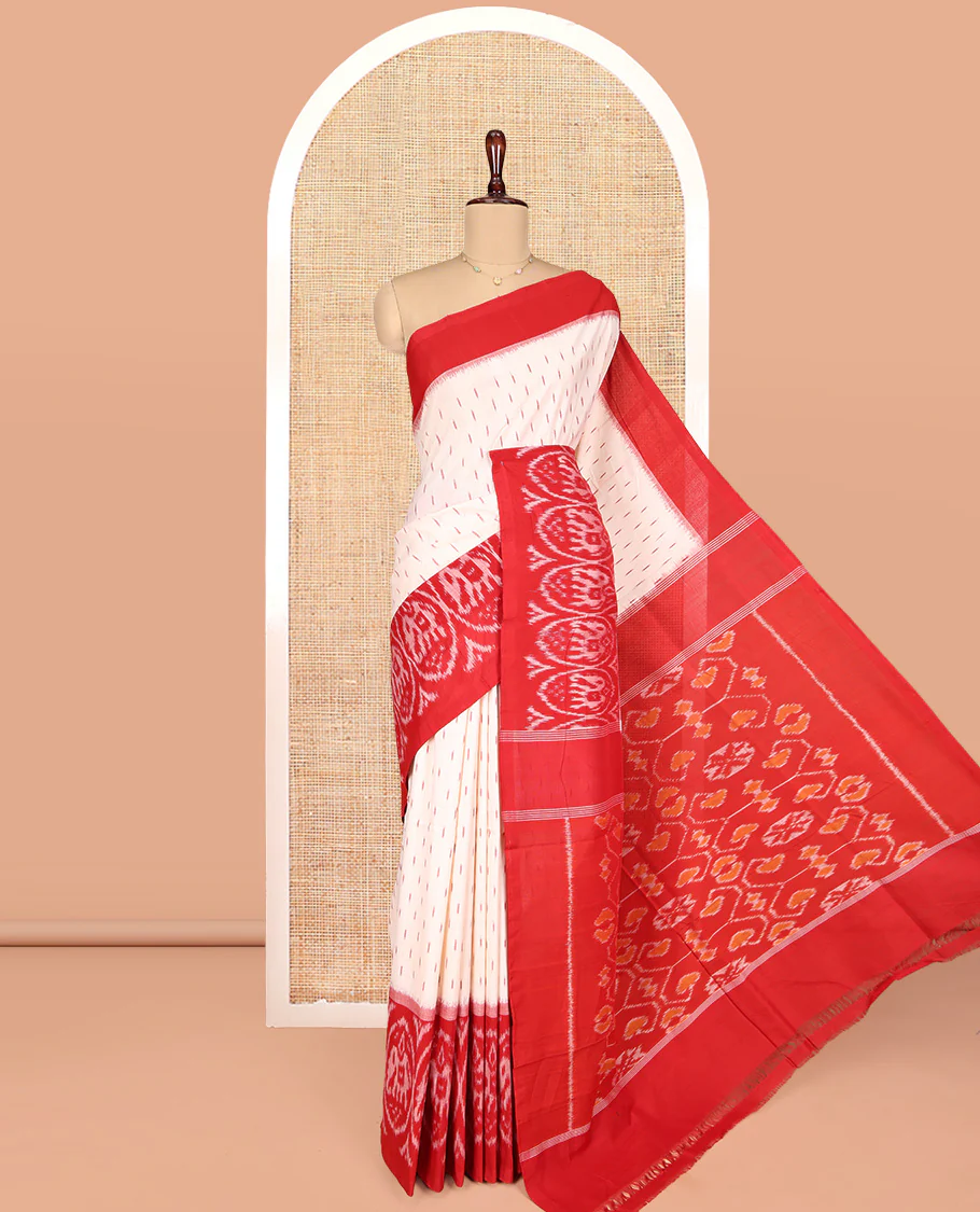 Cream Ikkat Cotton Saree, Features Ikkat Buttas All Over Its Body, Complemented by a Contrast Ikkat-Style Round Elephant Border, Intricately Designed Pallu, and Has No Blouse