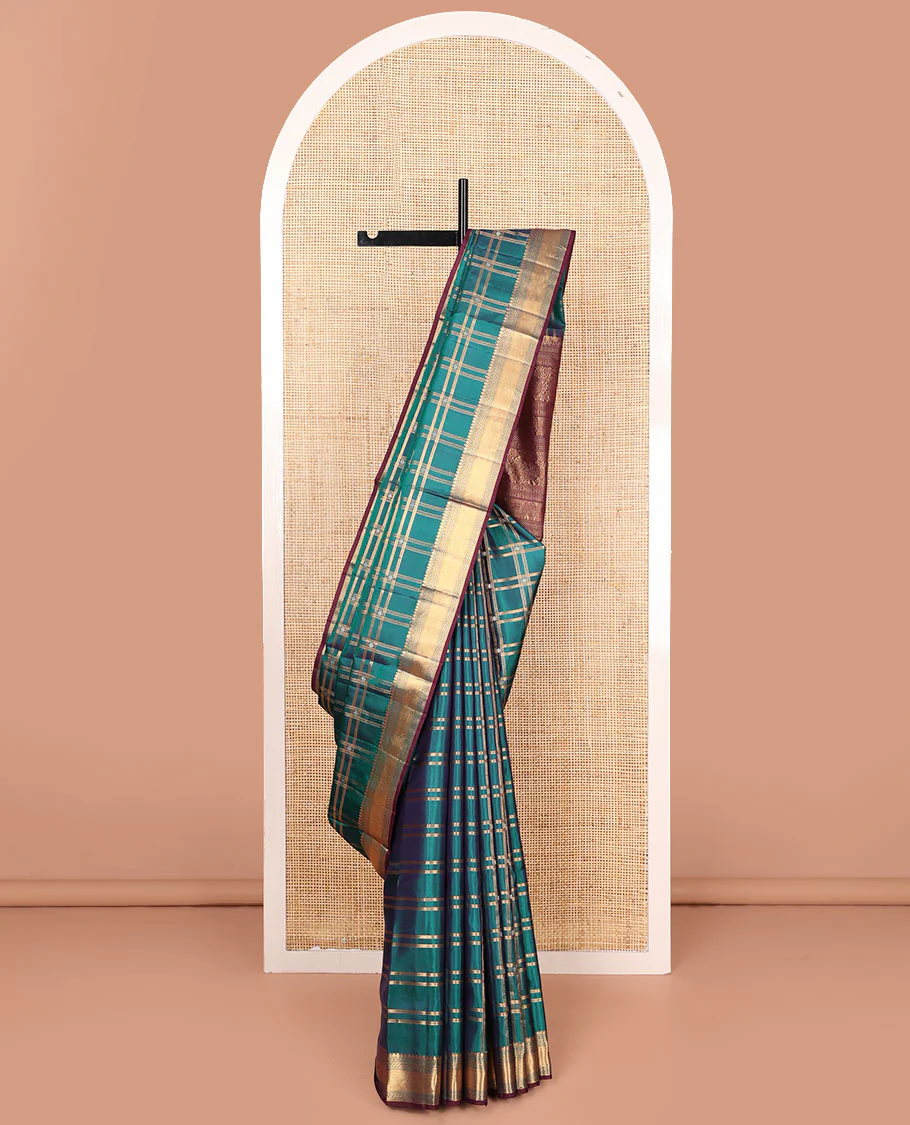 Green butta enclosed checked Mayuri soft silk saree, zari border of thilakam mokku, banaras, muthu, puli nagam, and vanki designs, and contrast pallu of mayil and yaanai designs