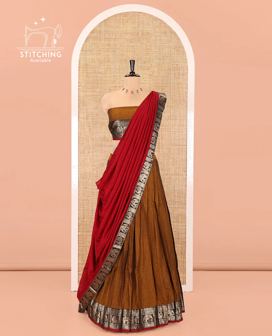 Mustard-Red Mercerised Cotton Half-Saree Features Plain with Contrast Traditional Zari Bordered Skirt, Paired with a Matching Blouse, and Comes with a Contrast Bordered Dhavani