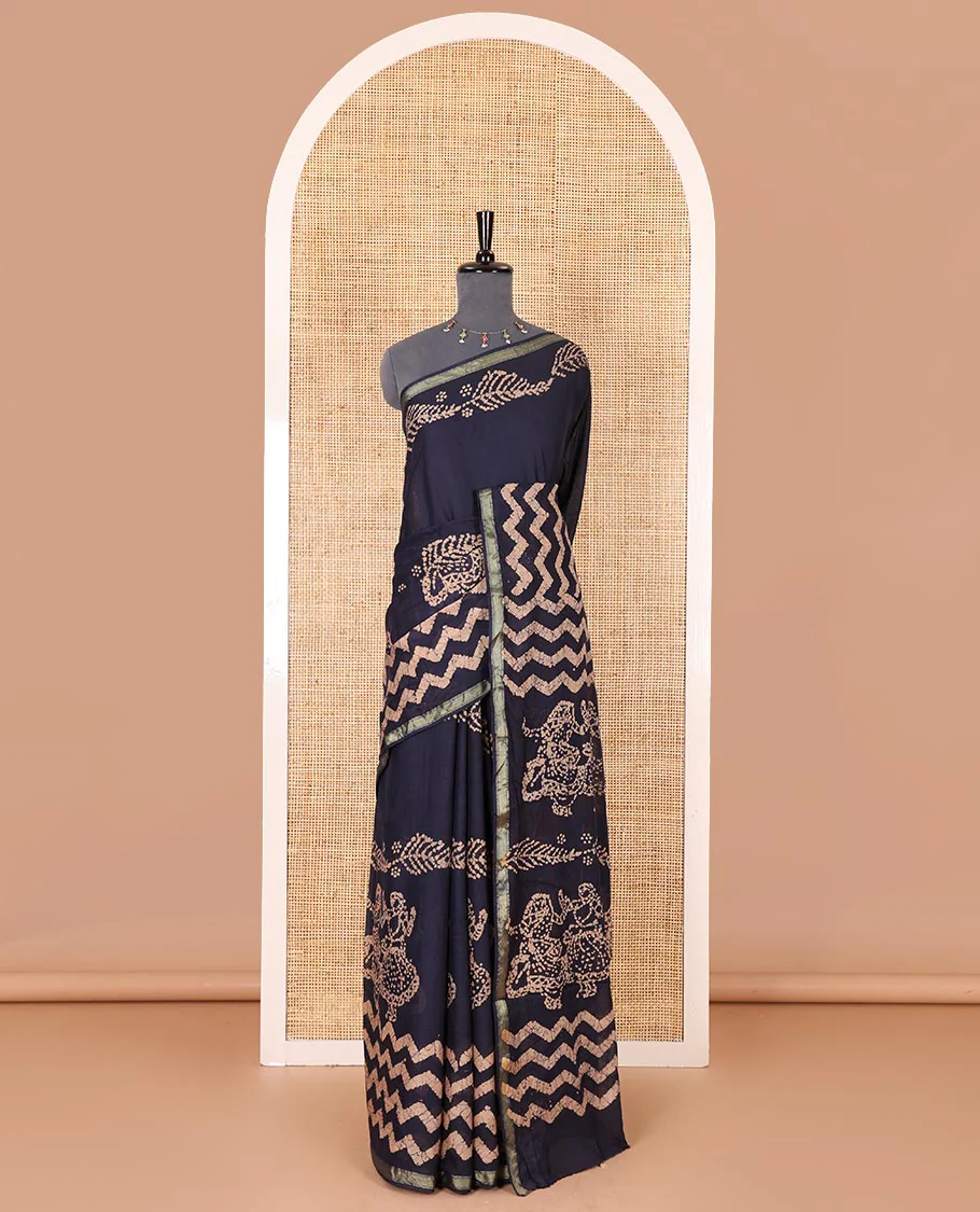 Navy blue wax batik-style zig-zag printed pure cotton saree, gold zari piping border, human figurines batik printed pallu, and a matching blouse - Image 2