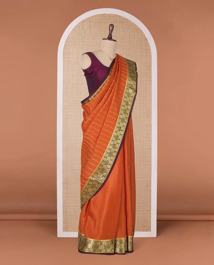Orange zari buttas Mysore silk saree, contrast peacock chakram zari buttas border, and pallu steeped with traditional designs