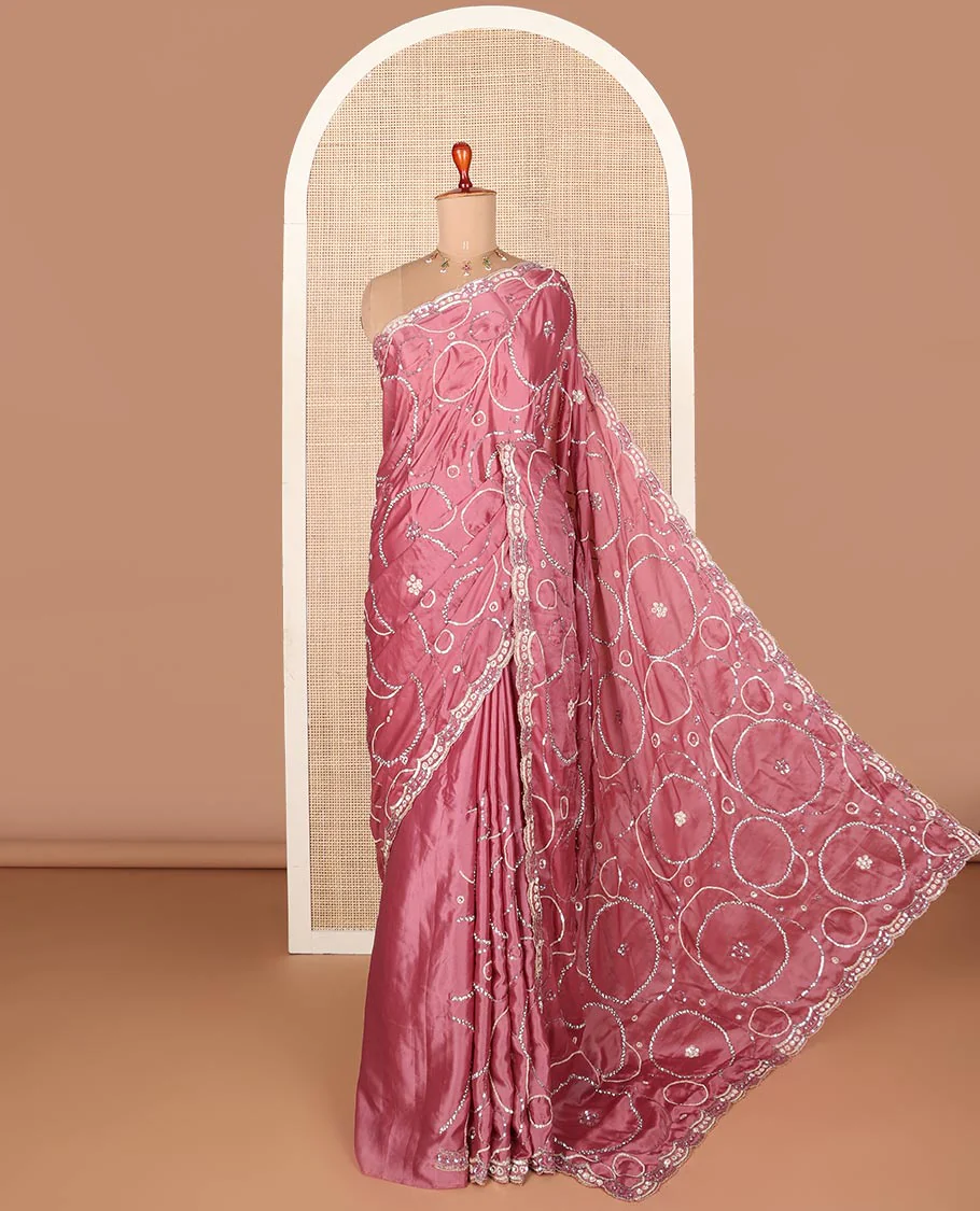 Pink embroidered designer saree features circular-shaped motifs woven in stones & sequins, scallop embroidered border