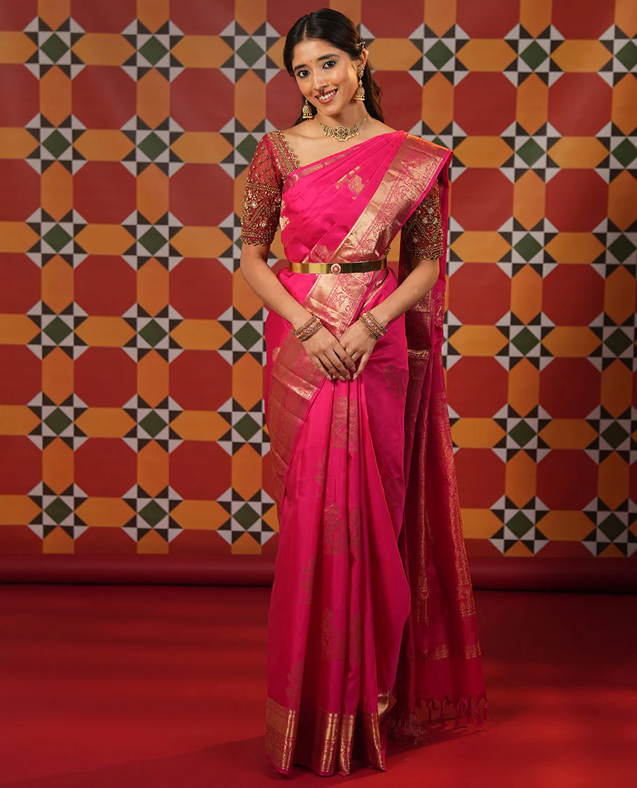 Pink singam and yaanai zari buttas woven Vasundhara silk saree, zari border of mayil kann, rudraksham, muthu, mayil, and yaali designs, and intricate pallu
