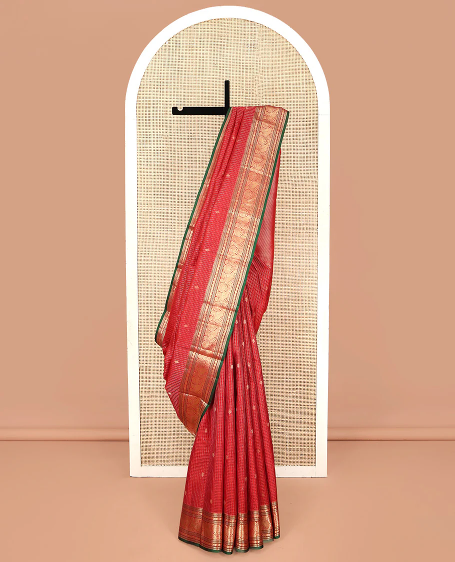 Red Kanchipuram Silk Saree, Richly Detailed with Zari Butta Enclosed Checks on Its Body, Highlighted by Zari Border of Rekku, Poun, Banaras, and Mayil Kann Designs, Diagonally Striped Pallu, and Paired with a Contrast Blouse