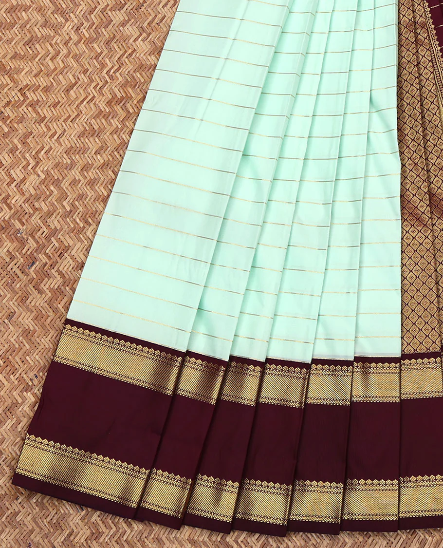 Turquoise Budget Silk Saree, Dazzled with Zari Stripes on Its Body, Complemented by a Contrast Traditional Zari Designs Woven Rettai Pettu Border, Grand Jaal Pallu, and Paired with a Contrast Blouse