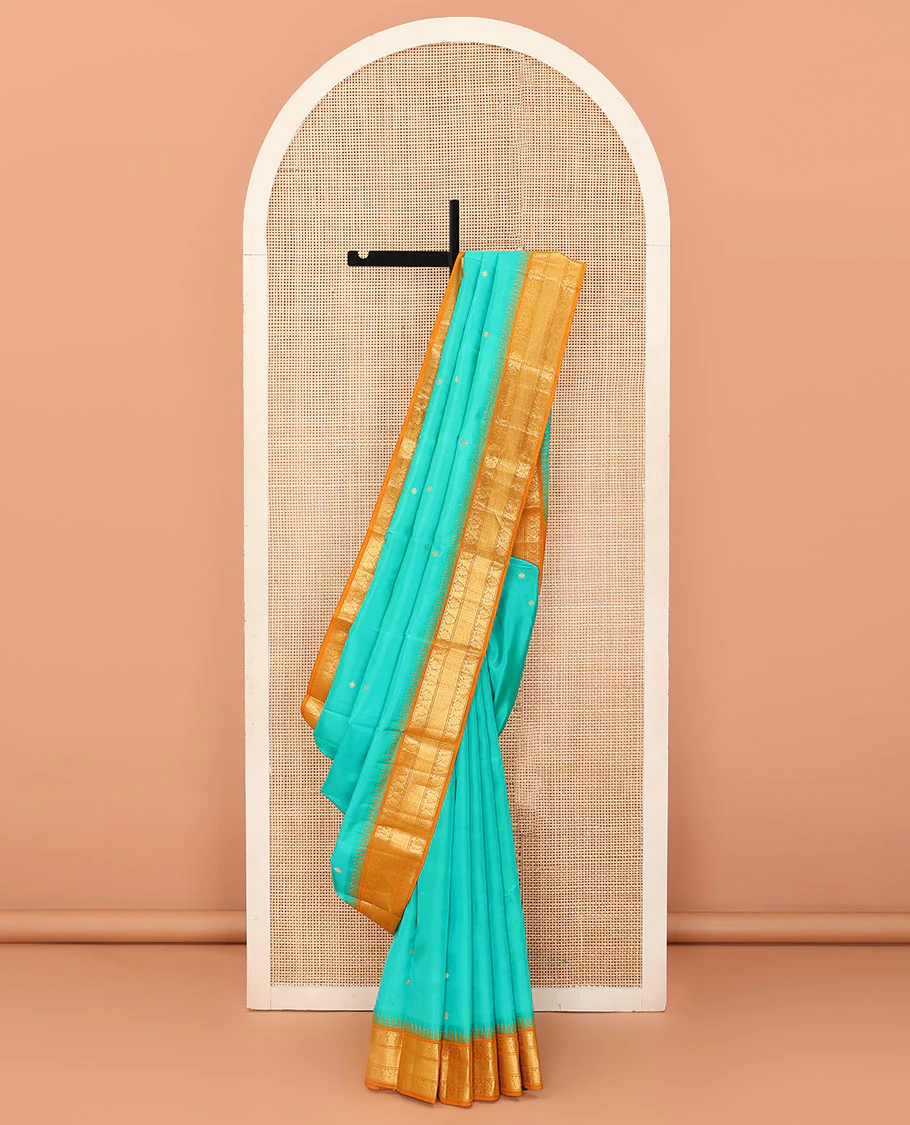 Turquoise buttas Bangalore silk saree, contrast temple traditional zari border, and pallu of jaal designs