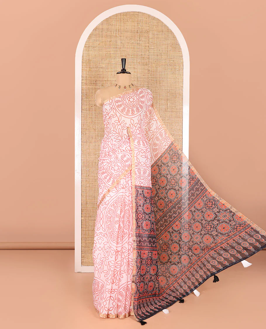 white bandhani-style floral and chakra printed saree, zari piping border, contrast ajrakh printed pallu, and contrast ajrakh printed blouse