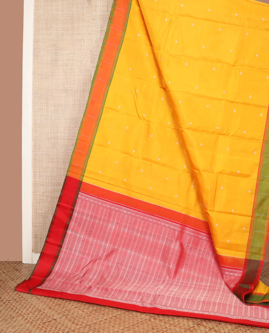 Yellow buttas Kanchipuram silk saree, contrast border of malli mokku designs, and pallu of geometric designs - Image 3